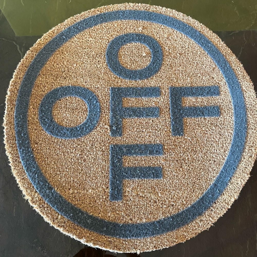 An off white circle floor mate